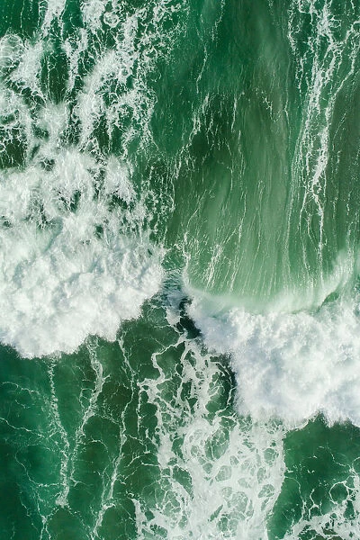 Aerial view of waves splashing in sea
