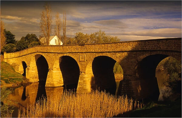 Afternoon light sweeps over the historic convict built stone bridge at Richmond in southern Tasmania