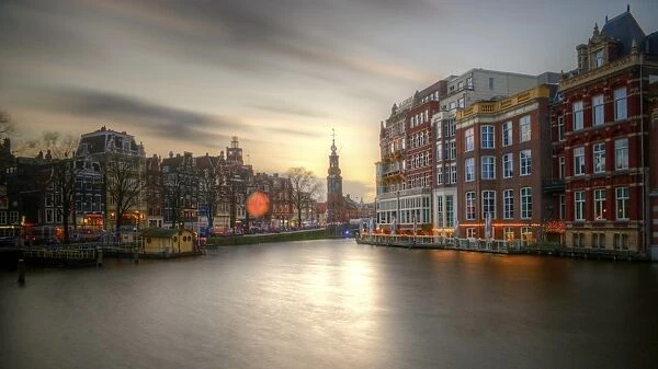 Amstel river and Munttoren Amsterdam sunset view