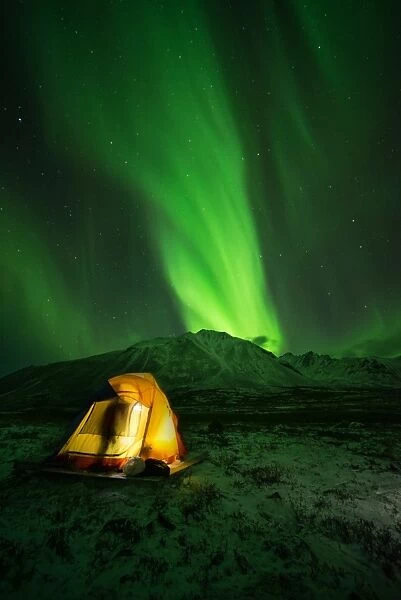 Blow. Aurora Borealis at tombstone mountain with people camping