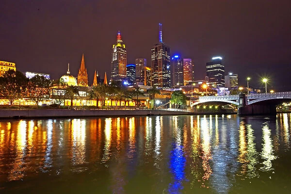 Australia, Melbourne, illuminated cityscape reflected in Yarra River