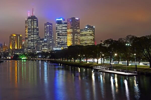 Australia, Melbourne, Yarra river and cityscape illuminated at dusk