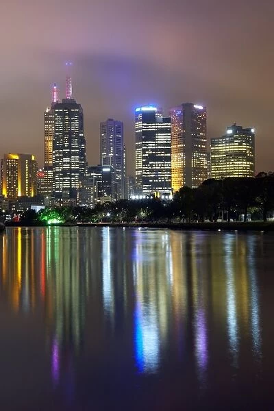 Australia, Melbourne, Yarra river and cityscape illuminated at dusk
