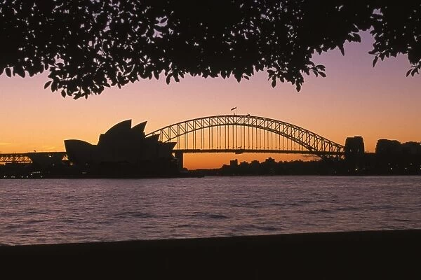 Australia, New South Wales, Sydney, silhouette of Opera House and Sydney Harbour Bridge at sunset