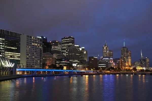 Australia, Victoria, Melbourne city skyline and Yarra River, night