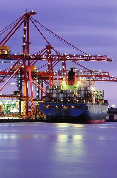 Australia, Victoria, Melbourne, container ship in shipyard, twilight