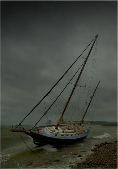 Framed Print : Beached yacht in storm
