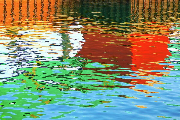 Blue, green, red, orange and brown colours reflected in the sea at the commercial dock at the Port Lincoln Wharf. Port Lincoln. South Australia