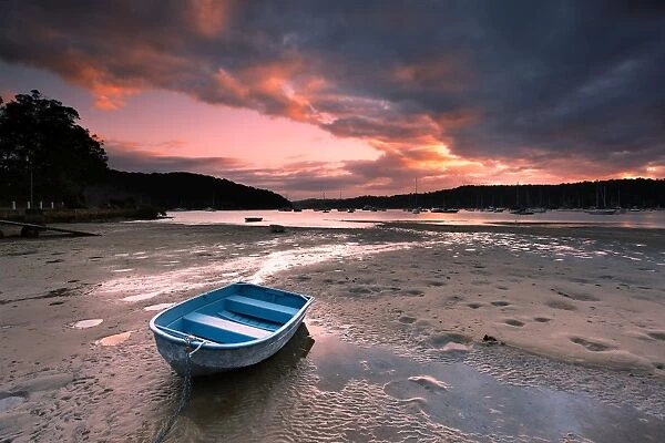 Boat on beach at sunrise