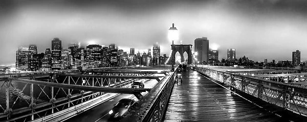 Brooklyn Bridge and Manhattan skyline under heavy fog in black and white