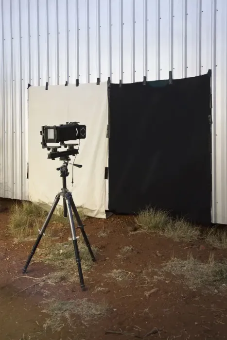 Framed Print : A camera and back drop set up outdoors