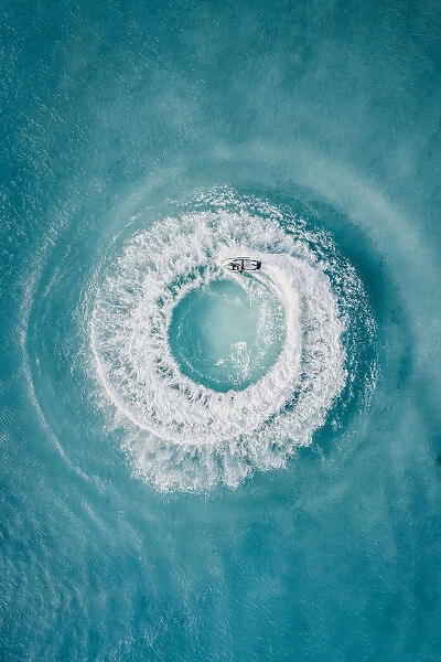 Circle patterns created by jet ski at sea as seen from directly above, Barbados