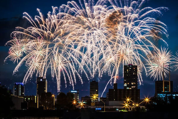 Colourful fireworks over city buildings
