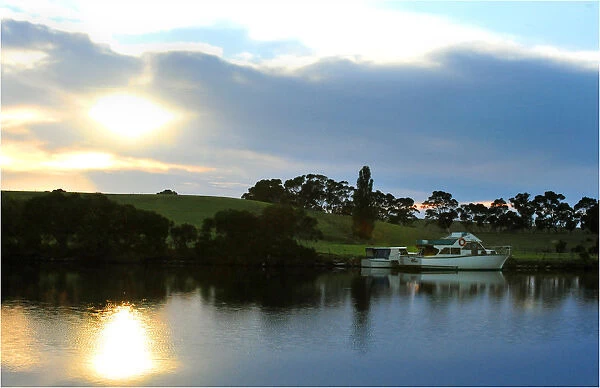 Dawn breaking though the clouds on the Nicholson river, east Gippsland, Victoria
