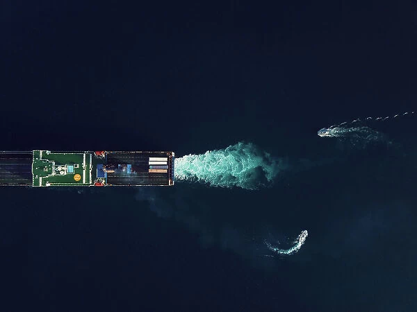 Directly above view of two pilot boats commanding a RoRo cargo ship into the harbour
