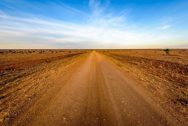 Dirt road crossing Mundi Mundi Plains in New South Wales