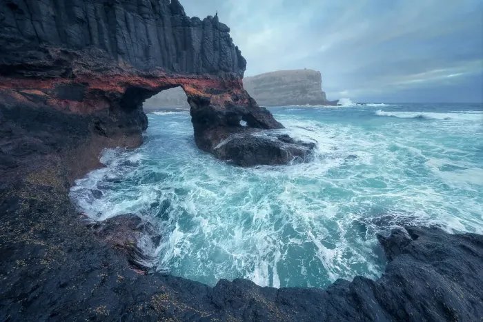 Framed Print : Dramatic rocky cliffs, with rock columns and caves, breaking waves and distant coastline in Victoria, Australia