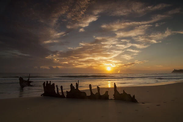 A dramatic sunrise on Dicky Beach with the wreck of the SS Dicky in the foreground