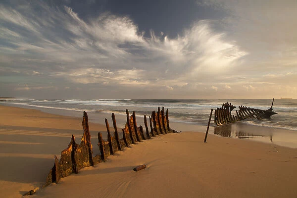 A dramatic sunrise on Dicky Beach with the wreck of the SS Dicky in the foreground
