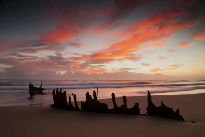 Framed Print : A dramatic sunrise on Dicky Beach with the wreck of the SS Dicky in the foreground Framed Print : A dramatic sunrise on Dicky Beach with the wreck of the SS Dicky in the foreground