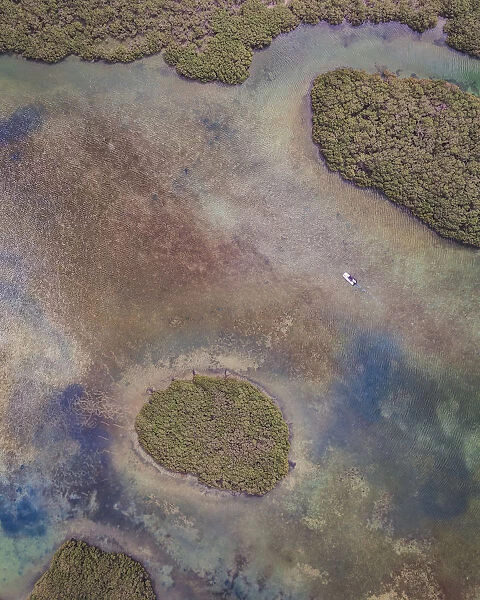 Drone perspective of a small boat in the marshlands, Shark Bay, Australia