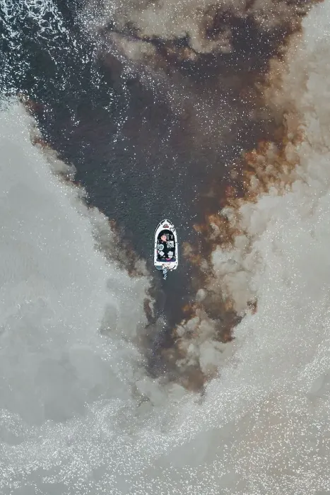 Framed Print : Drone photo looking down on a speedboat between clouds of sediment flowing down the Mary River, Northern Territory, Australia Framed Print : Drone photo looking down on a speedboat between clouds of sediment flowing down the Mary River, Northern Territory, Australia