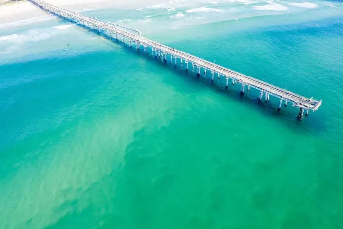 Framed Print : Drone view of a Long sand pumping jetty out into the clear ocean water Framed Print : Drone view of a Long sand pumping jetty out into the clear ocean water