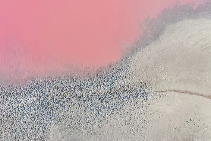 Framed Print : Drone view point of the pink shades of color, patterns and textures over Pink Lake waters with dark salty sandy soil