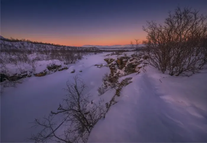 Framed Print : Dusk comes over a winter scene at Abisko National park in Lapland, Sweden