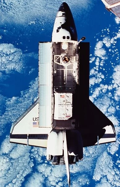 Elevated view of the space shuttle orbiting above the earth with its cargo bay open