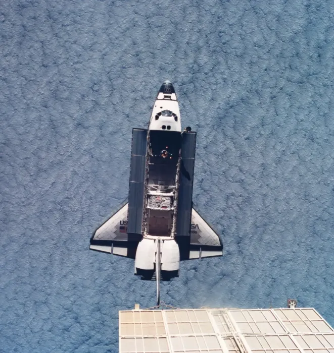 Framed Print : Elevated view of the space shuttle orbiting above earth with its cargo bay open Framed Print : Elevated view of the space shuttle orbiting above earth with its cargo bay open