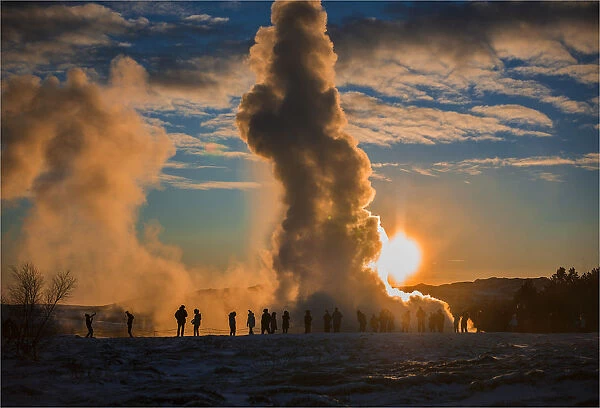 Erupting geysir during the late afternoon in winter, Haukadaisvegur, Iceland