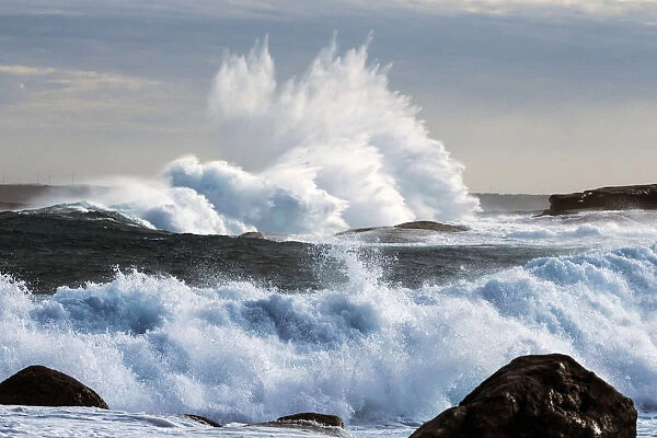 Extreme weather with waves crashing on coast