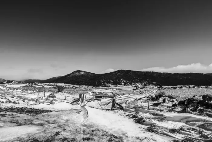 Framed Print : Fence and gate around a small snowy mountain Framed Print : Fence and gate around a small snowy mountain