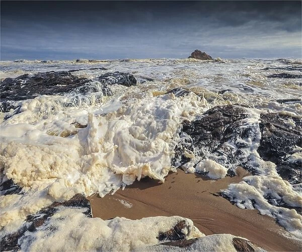 Foaming tidal sea surges, near the Arthur river estuary, west coastline of Tasmania