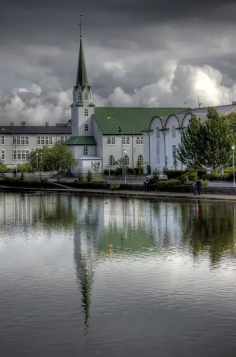 Framed Print : Frikirkjan church Tjornin lake cloudy reflections