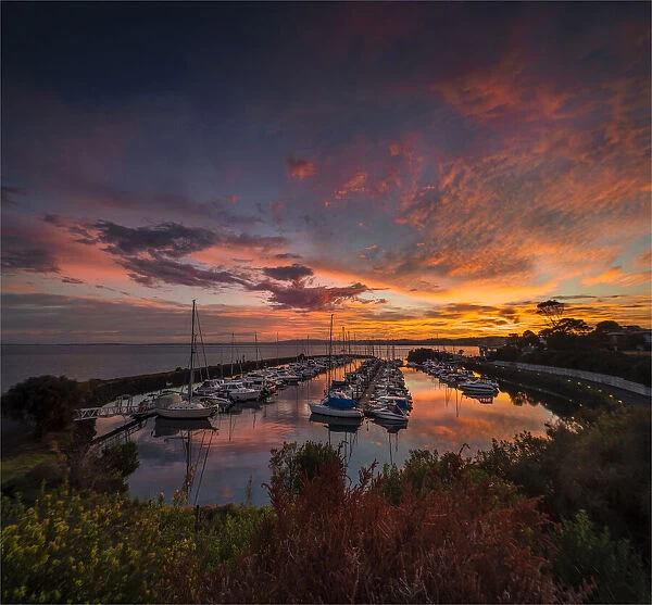 A golden dawn of fiery colours in the late summer, at Newhaven Yacht club marina, Phillip Island Bass Coast, Victoria, Australia
