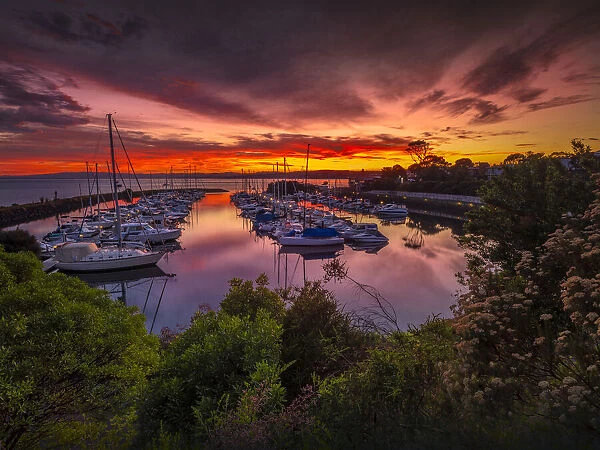 A golden dawn of fiery colours in the late summer, at Newhaven Yacht club marina, Phillip Island Bass Coast, Victoria, Australia