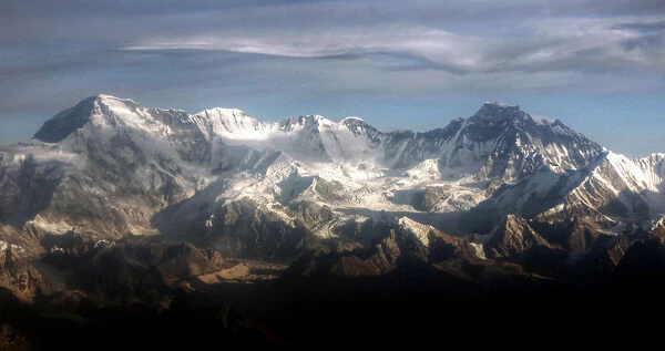 Himalayas. Scenic flight view of high Himalaya with snow on peaks and cloudy sky