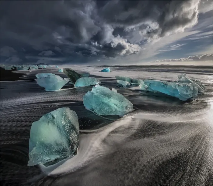 Framed Print : Jokulsarlon Beach in winter, just after a huge storm hit the coastline. Ice bergs from the nearby lagoon have been swept up onto the coastline and surge in and out with the tide Framed Print : Jokulsarlon Beach in winter, just after a huge storm hit the coastline. Ice bergs from the nearby lagoon have been swept up onto the coastline and surge in and out with the tide