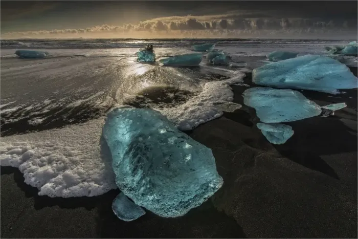 Framed Print : Jokulsarlon Beach in winter, just after a huge storm hit the coastline. Ice bergs from the nearby lagoon have been swept up onto the coastline and surge in and out with the tide Framed Print : Jokulsarlon Beach in winter, just after a huge storm hit the coastline. Ice bergs from the nearby lagoon have been swept up onto the coastline and surge in and out with the tide