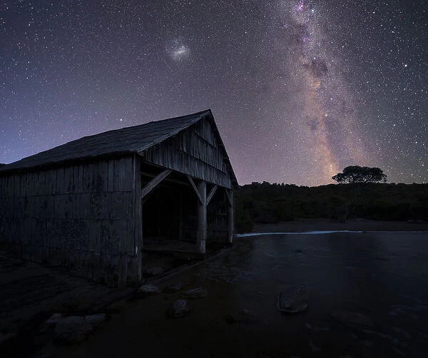 lake and boast shed under night sky tasmania