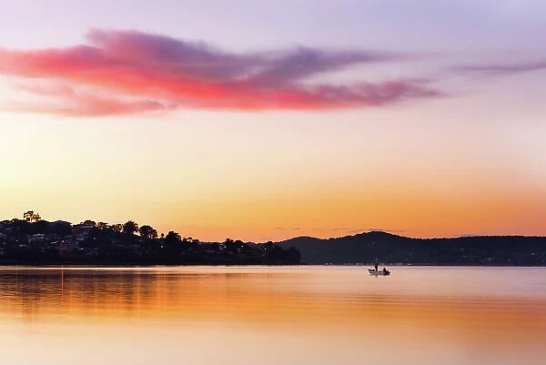 lake sunrise with fisherman