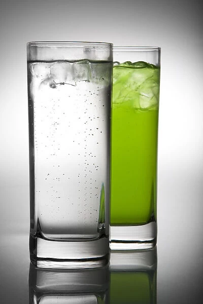 lemonade and green drink in pair of glasses