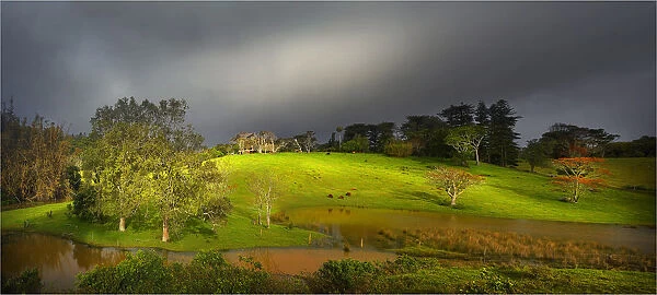 Light before an approaching storm in the valley and on the farmland near the Melanesion Church, Norfolk Island South Pacific
