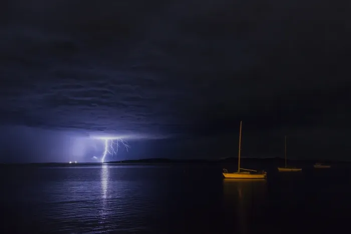Framed Print : Lightning over moored yacht