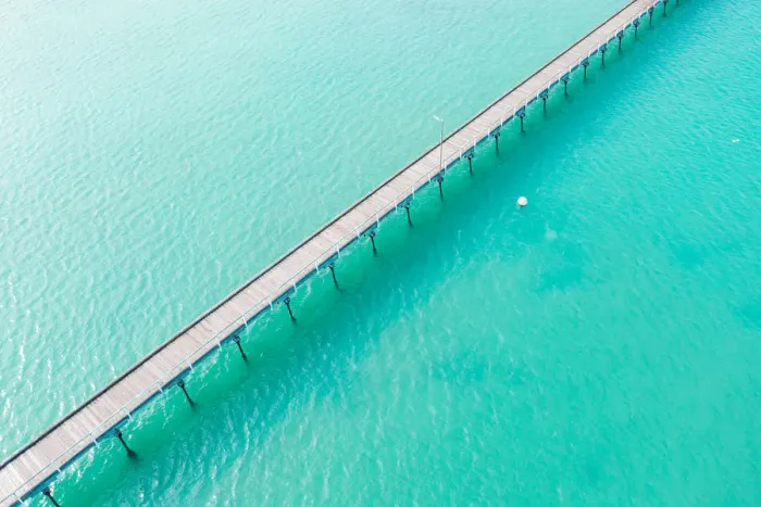 Framed Print : Long jetty out into the clear aqua ocean water Framed Print : Long jetty out into the clear aqua ocean water
