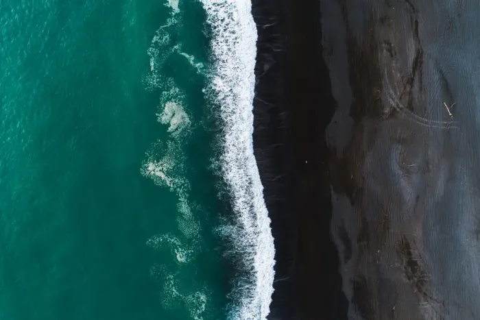Framed Print : Looking down at black sand beach