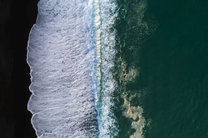 Framed Print : Looking down at black sand beach