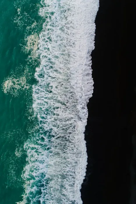 Framed Print : Looking down at black sand beach